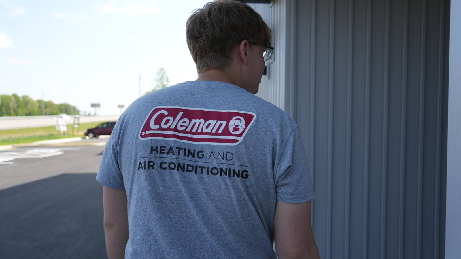ATC crew member in Coleman Heating and Air Conditioning gear