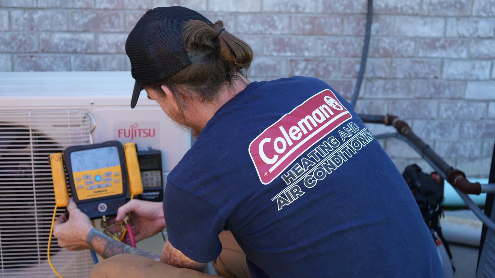 ATC technician checking refrigerant pressures on a mini-split system